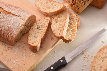 Bread cut into slices on cutting board of kitchen top