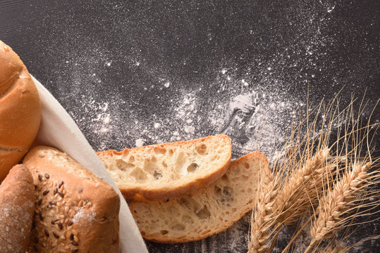 Bread On Basket And Black Wooden Table Close Up Top