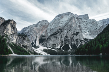Fototapeta premium Pragser Wildsee in the summer from a long distance with clouds and dark colors