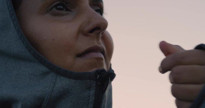 young indian woman runner preparing early morning running workout zip up hoodie ready for training exercise in city at sunrise close up