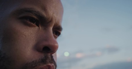 young man runner resting after intense running exercise exhausted athlete breathing tired in urban city after jogging at sunrise close up face - Powered by Adobe