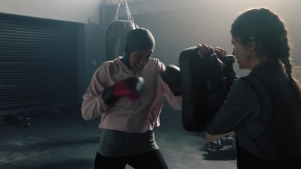 muslim woman athlete training kickboxer coach teaching self defence friends enjoying intense exercise workout together in gym practice slow motion