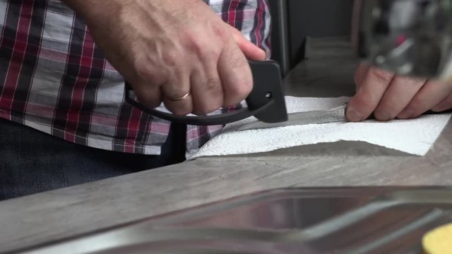 The man is sharpening a kitchen knife