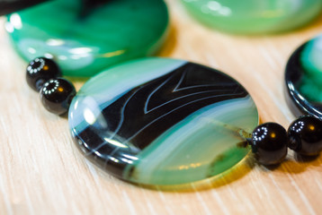 Large polished beads of beautiful translucent green agate gemstone, macro
