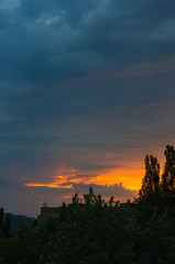 Landscape with dramatic light - beautiful golden sunset with saturated sky and clouds.