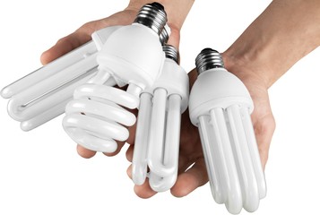 Two Hands Holding Four Energy Efficient Bulbs - Isolated