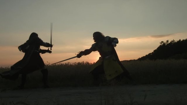 Fight at sunset. Wide shot.