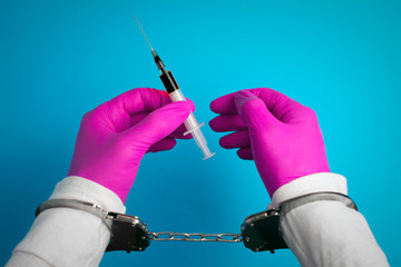 syringe in hand is handcuffed, medical gloves. stop selling unapproved or misbranded prescription...