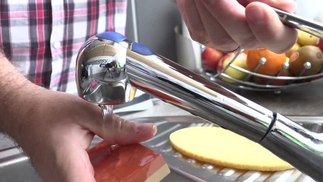 The man is sharpening a kitchen knife