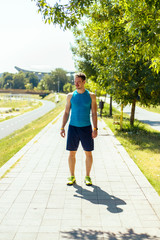 Man prepare to running on a track in a sunny day