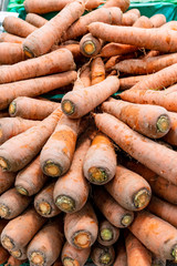 Carrots are vegetable that has rich in vitamins, beta-carotene, anti-oxidation and good for making salad. They are displaying on stall to sell to somebody, and looks very fresh.