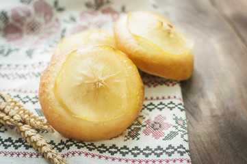 donuts or bun with apple and sugar on table