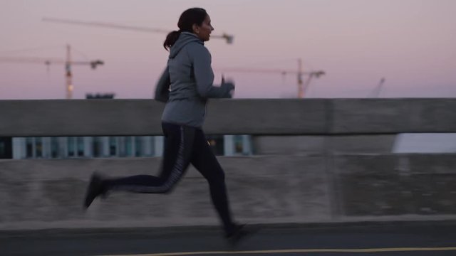 mature athlete woman running cardio exercising female athlete resting exhausted after intense jogging workout in city at sunrise