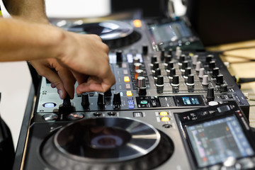 Fototapeta na wymiar DJ mixing tracks on professional DJ sound controller
