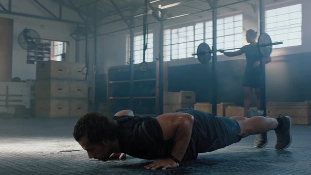 healthy man training push ups exercise intense muscle workout muscular bodybuilder doing superman enjoying extreme fitness routine in gym slow motion