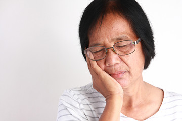 Fototapeta premium Older Asian women are sad because of toothache.