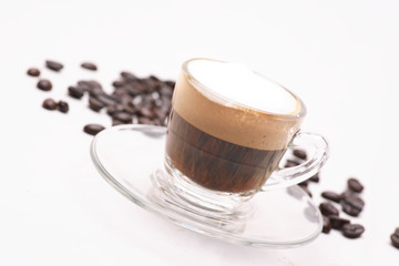 Hot Cappuccino  coffee  in clear glass on a white background in the studio.	