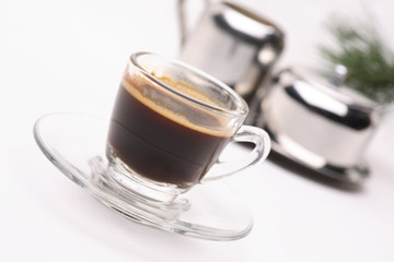 hot coffee  in clear glass on a white background in the studio.	