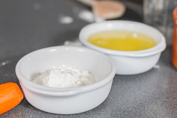 white flour in a ramekin on the kitchen worktop