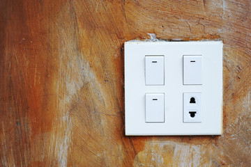old brown grunge brown concrete with dirty switches and plug socket