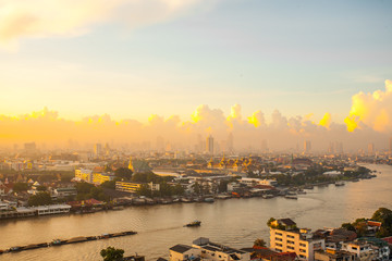 Sun rise The Chao Phraya River Behind the view of the royal palace in the corner.