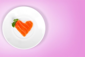 Raw salmon slice in shape of heart