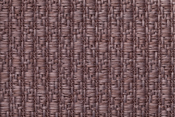 Brown knitted woolen background with a pattern of soft, fleecy cloth. Texture of textile closeup.