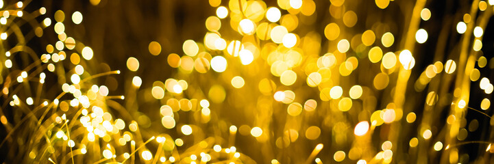 Gold abstract bokeh background Christmas background. Festive abstract background with bokeh defocused lights and stars