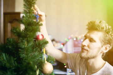 young bearded man at home doing domestic preparation to the christmas new year holidays concept f
