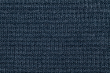 Fototapeta na wymiar Dark blue fluffy background of soft, fleecy cloth. Texture of light nappy textile, closeup.