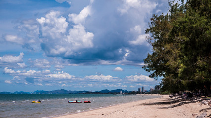 Beautiful Cha-am beach with blue sky and pine trees.