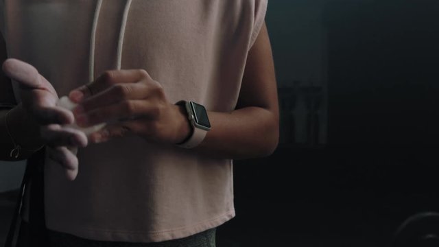 fitness woman athlete using chalk powder  attractive sportswoman preparing training workout in gym ready for strength exercise slow motion