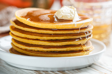 Fresh homemade pumpkin pancake with honey and butter in a white plate. Tasty Traditional healthy Breakfast for gourmets