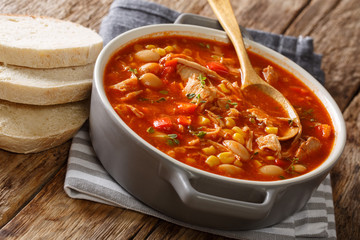 Brunswick stew freshly cooked from pulled meat with vegetables, spices and barbecue sauce close-up...