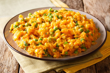 Delicious African food Irio spicy puree of sweet potato with green peas and corn close-up on a plate. horizontal