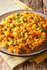 Delicious Kenyan food - Irio sweet potato with green peas and corn close-up on a plate. vertical
