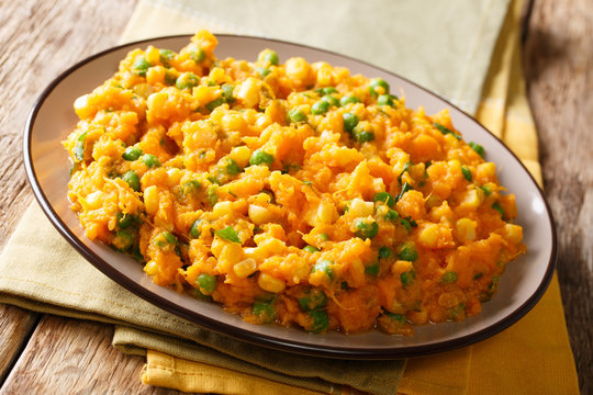 Kenyan vegetarian meal Irio puree of sweet potato with green peas and corn close-up on a plate. horizontal