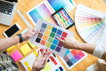 Fototapeta na wymiar Professional Creative architect graphic desiner occupation choosing the Color pantone palette samples for project on office desktop computer.