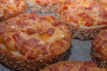 Quick Easy Snack. Sesame Bread Baked With Salami And Cheese On Oven Tray. Mini Pizza