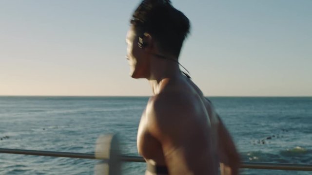 fit muscular young man running fast sprinting training intense cardio workout on beautiful ocean seaside sunset fitness lifestyle