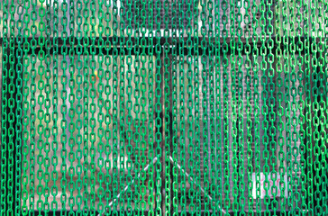 Green Plastic Chains curtain as background.