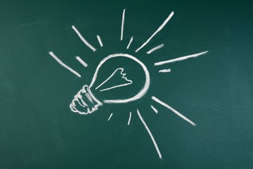 Lightbulb drawn on a blackboard - innovation concept