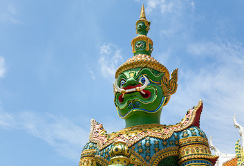 Giant,demon guardian statues decorating the buddhist temple Wat Arun or Wat Arun Ratchawararam Ratchawaramahawihan in Bangkok,Thailand