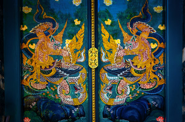 The magnificent door of the ancient buddhist Thai temple at Wat Suthat Thepwararam is a Buddhist temple in the city of Bangkok,Thailand