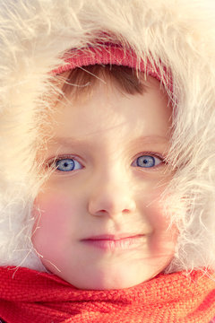 Portrait of a ruddy blue-eyed girl. Winter.