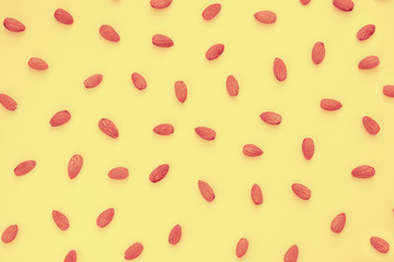 Nuts almonds on a yellow background, texture, pattern, top view, close-up, flatlay