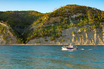Pleasure boat in the sea against the mountains