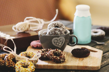 Attractive served donuts with milk and coffee