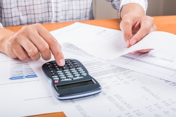 Close-up of a Businessman Analyzing Business Graphs with