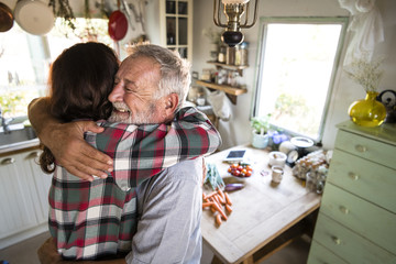 Father welcoming daughter in the kitchen